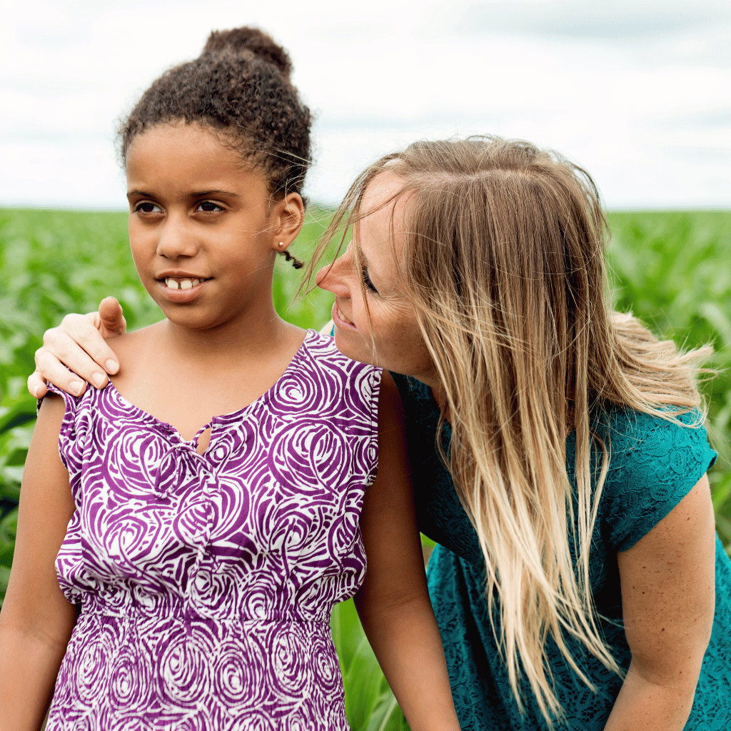 CHIRYO Outcomes and Intervention Services mother hand on shoulder of autistic daughter both smiling whist in the fields